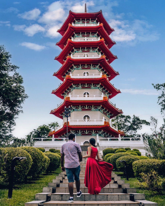 A couple standing in front of a chinese style pagoda at Chinese garden