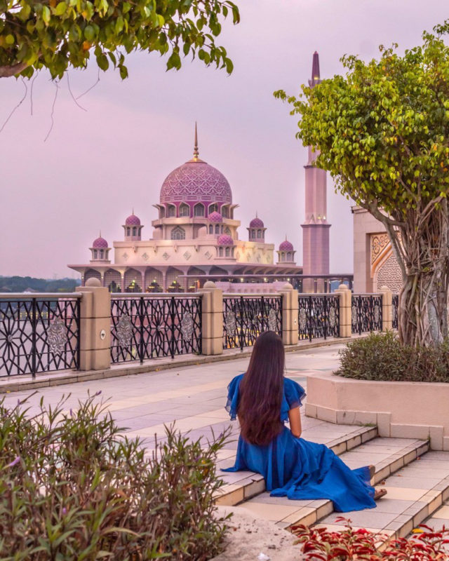A girl in blue looking at the pink mosque in Putrajaya in Kuala Lumpur