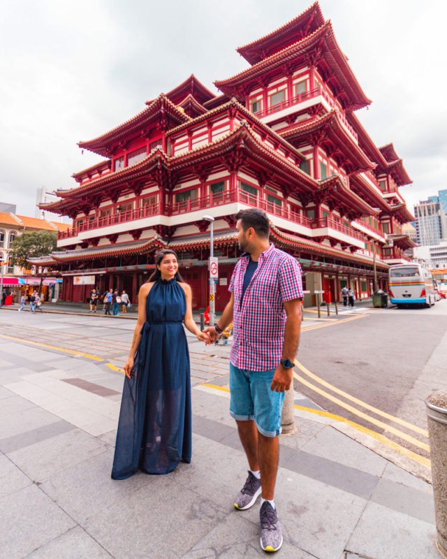 A couple standing in front of Buddha Tooth relic temple