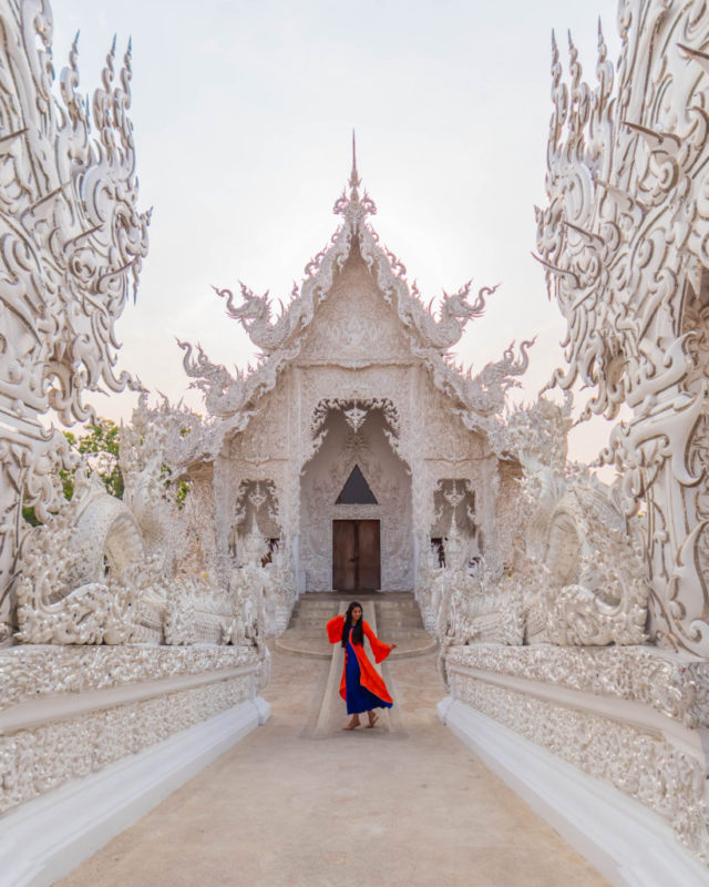 A girl standing in an all white temple