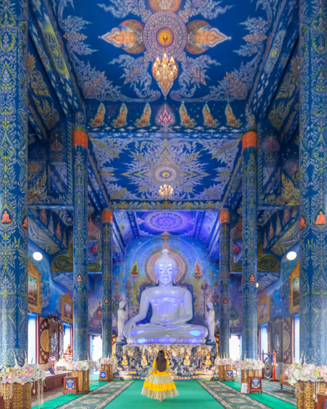 girl standing inside blue temple chiang rai