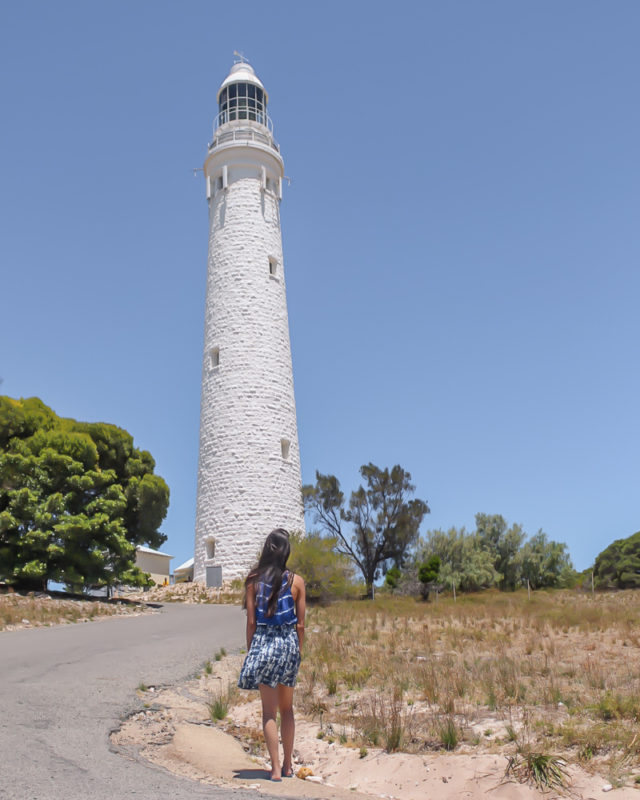 A girl staring at the white Wadjemup lighthouse