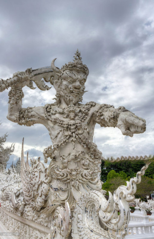 The statue of protector at bridge of white temple