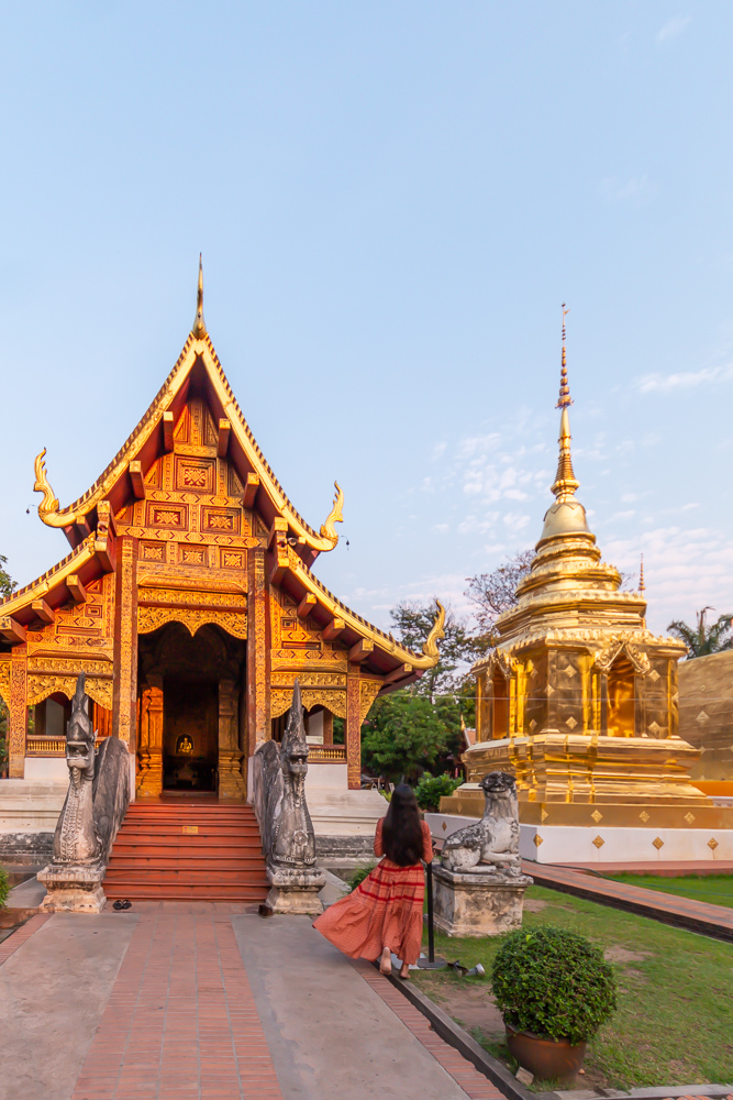 A girl in brown dress at wat phra singh early in morning