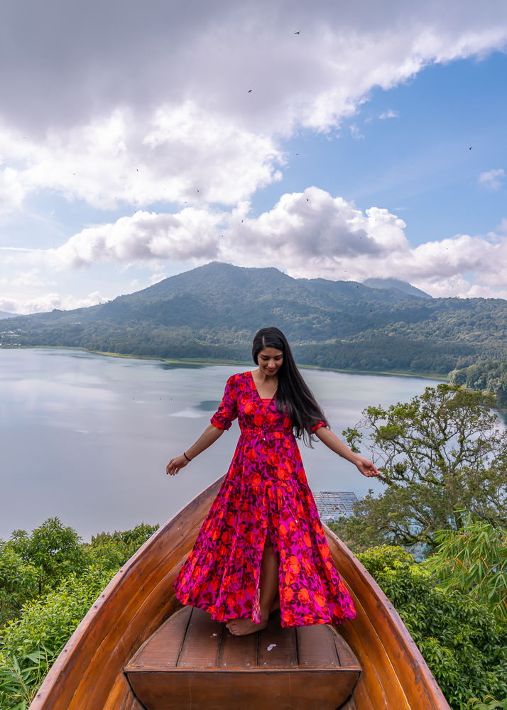 A girl in red dress posing at the boat installation at wanagiri hidden hills