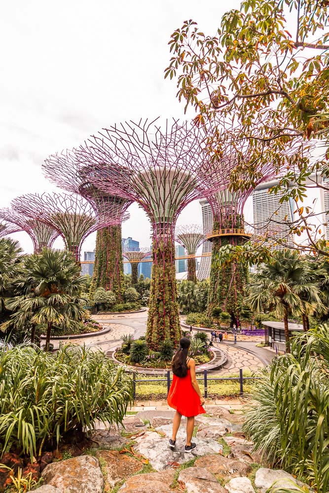 A girl in orange dress standing at Gardens of the bay, one of the best singapore instagram spots
