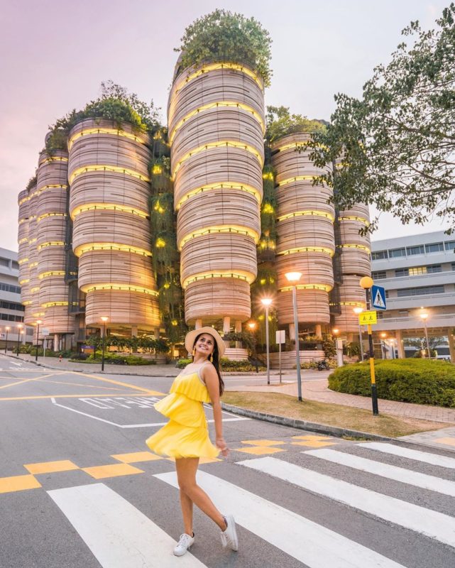 A girl in yellow dress posing at the hive in singapore