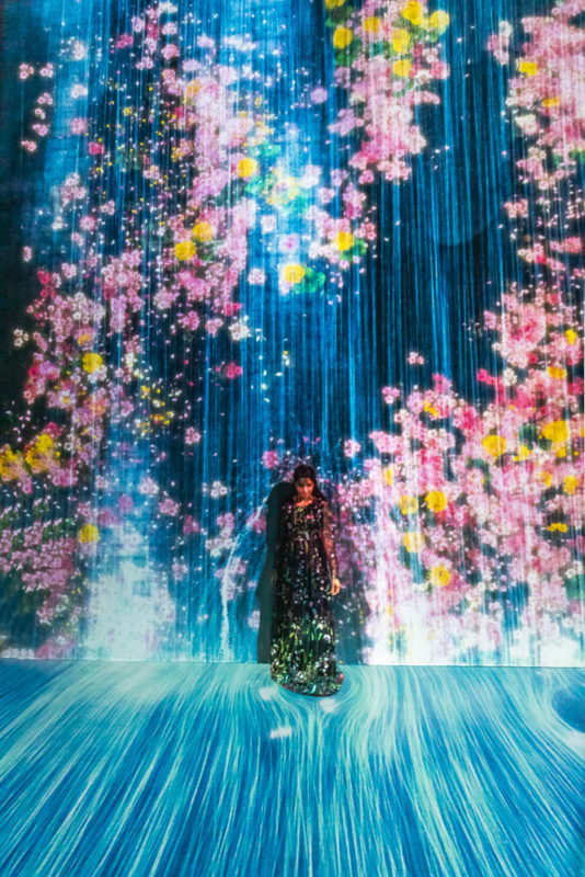A girl in black dress standing at an installation at artscience museum singapore